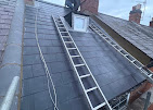 Slate roof with roofing ladder and chimney