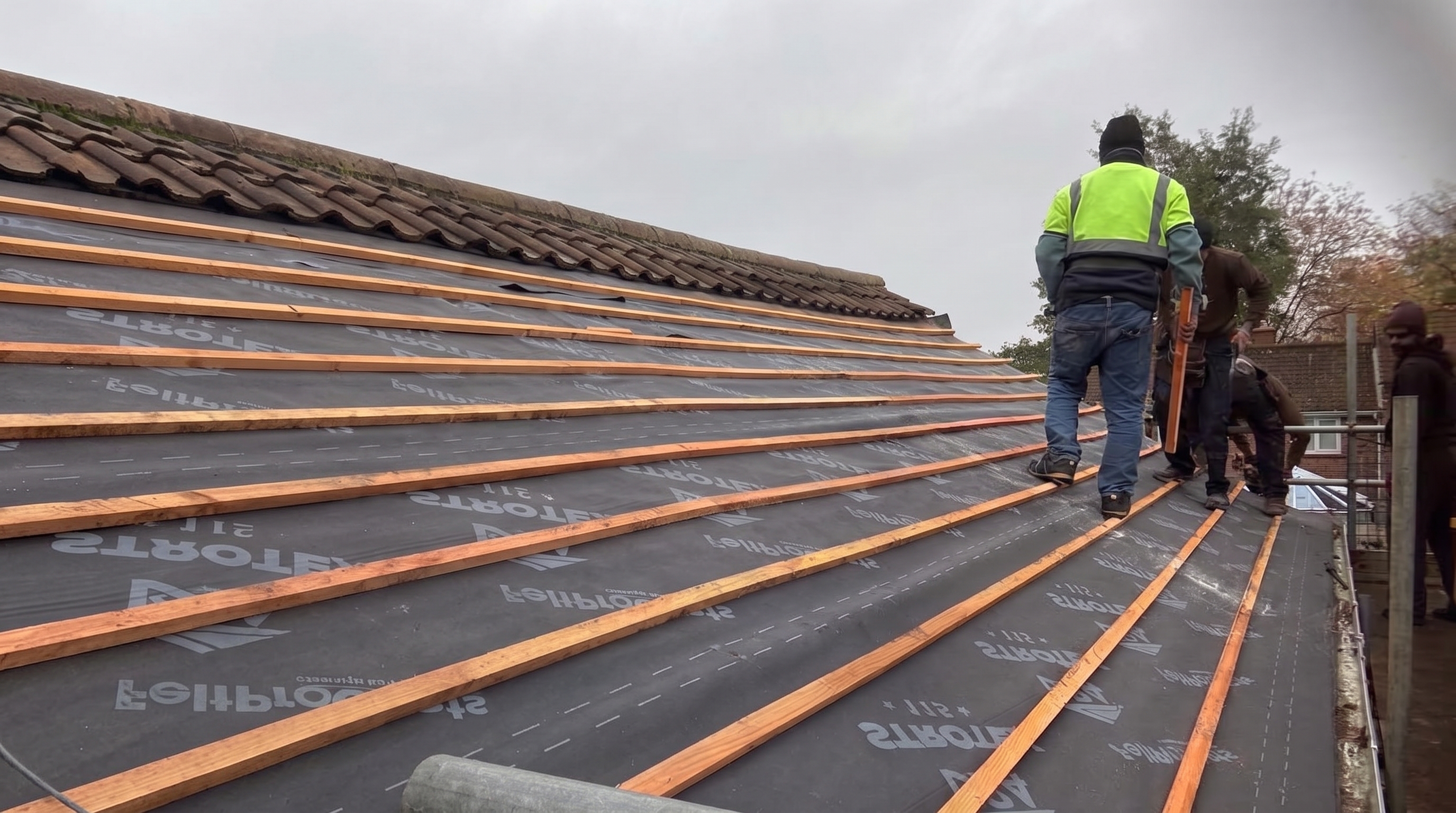 Roofing Plus team fitting new battens on a pitched roof